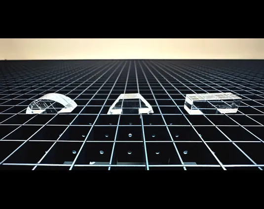 Acrylic shapes cut with Trotec CO₂ laser on a honeycomb cutting table