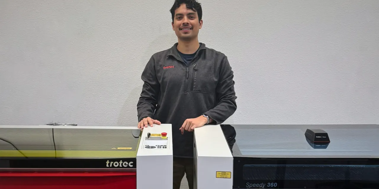 Man standing between Trotec Speedy 360 laser engraver and Ruby software interface module