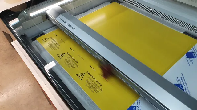 Trotec laser cutter engraving safety warning on yellow acrylic sheet
