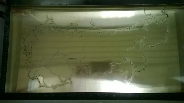 Metal sheet engraved with map outline using Trotec laser cutter for precision engraving work