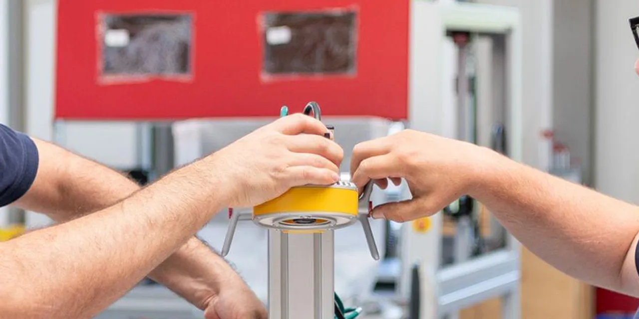 Trotec technicians assembling component for laser engraving machine in manufacturing facility