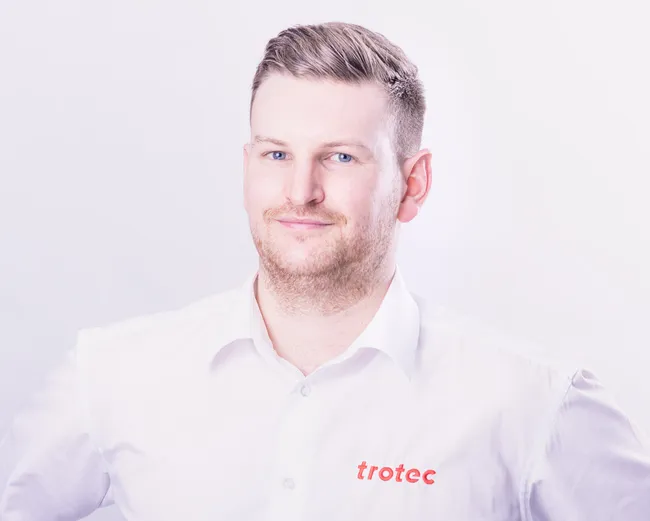 Trotec team member in branded shirt representing laser engraving and cutting technology