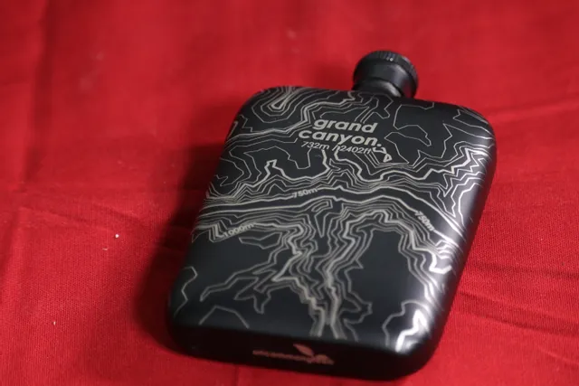 Black flask with Grand Canyon topographic map engraved using Trotec laser engraving machine
