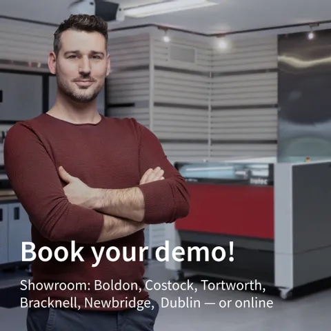 Man standing in Trotec showroom with Speedy series laser cutter in background