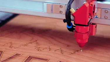 Trotec CO₂ laser engraving machine etching detailed design onto wooden surface