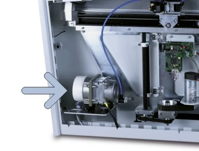 Internal view of Trotec laser cutter showing exhaust fan unit and electronic components