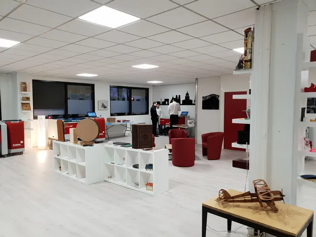 Trotec Speedy 400 laser engravers in modern demo room with wood and acrylic samples