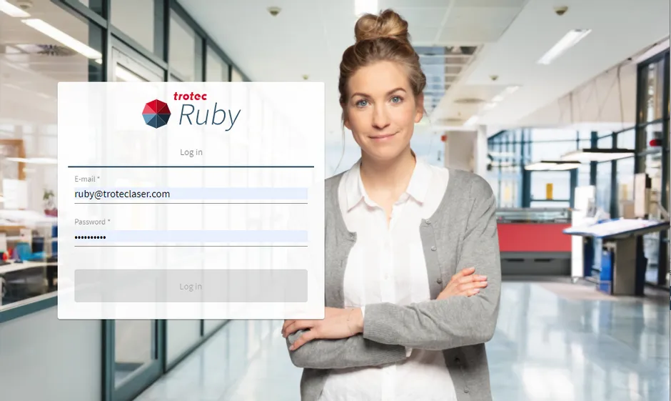 Trotec Ruby® laser software login screen in modern office with woman standing confidently