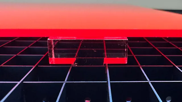 Acrylic sheet and spacer on Trotec laser cutter honeycomb table for laser cutting setup