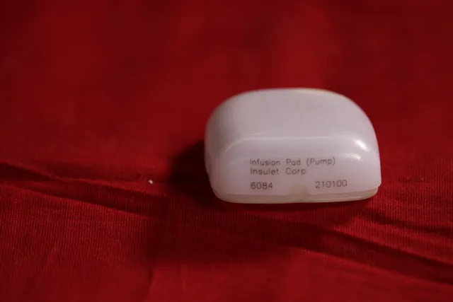 Insulet Corp infusion pod pump with laser-marked label on white plastic casing