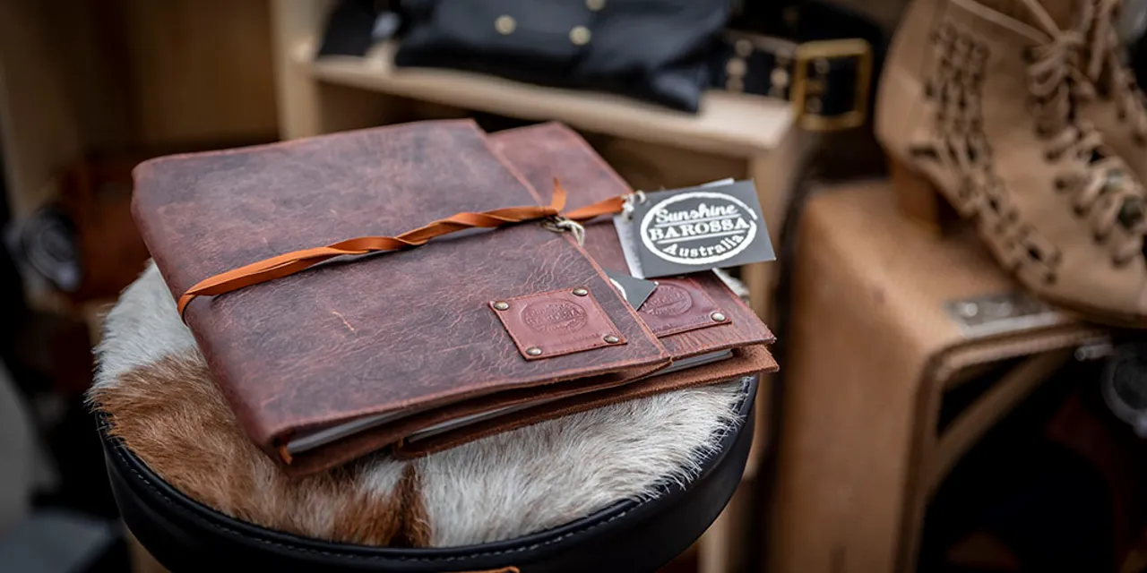 Laser-engraved leather notebooks with custom logo tags made using Trotec CO₂ laser cutter