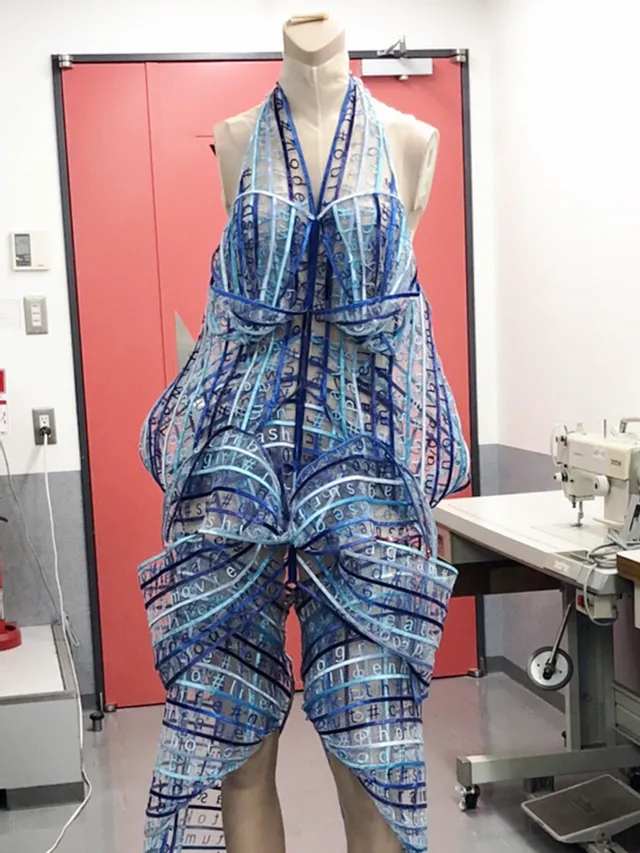Futuristic dress made from laser-cut acrylic panels, likely designed using Trotec laser cutting technology