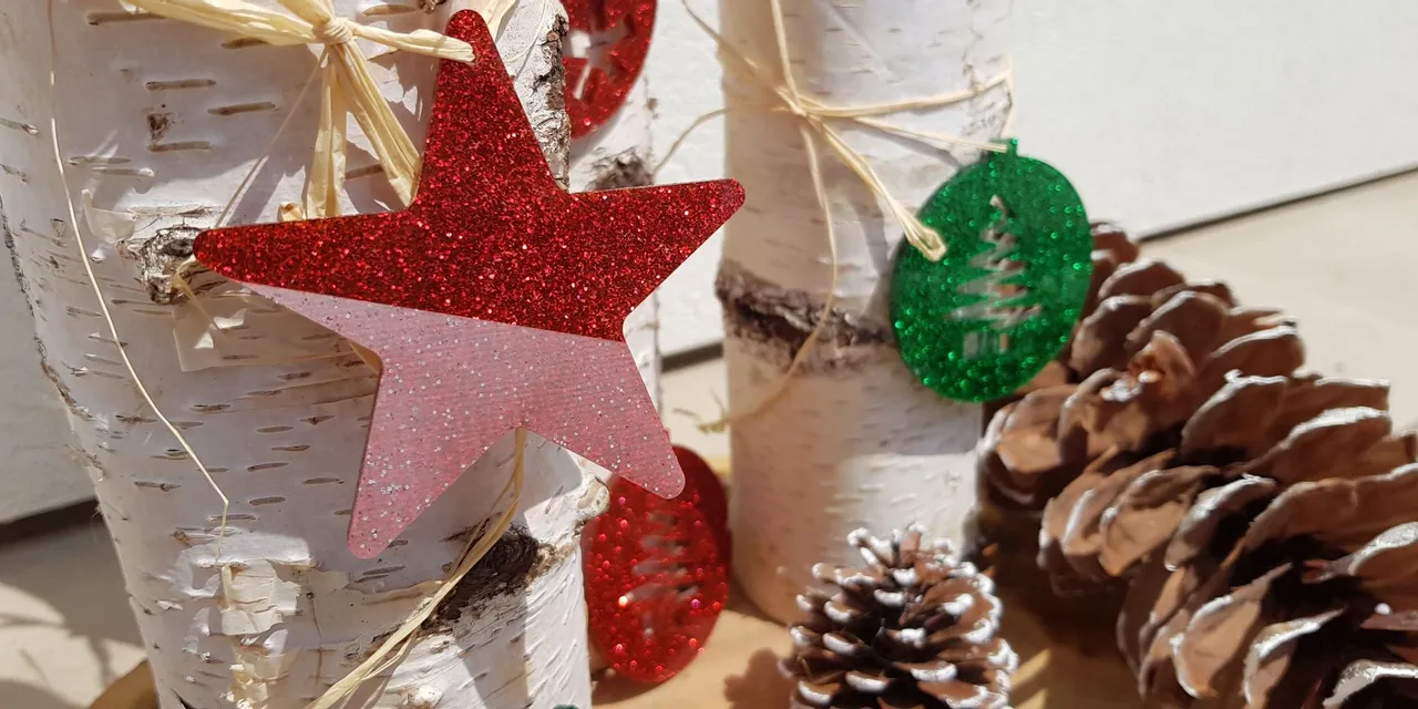 Glittery laser-cut Christmas ornaments on birch logs made with Trotec laser cutter