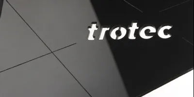 Trotec laser cut logo on black acrylic using high-precision CO₂ laser cutter