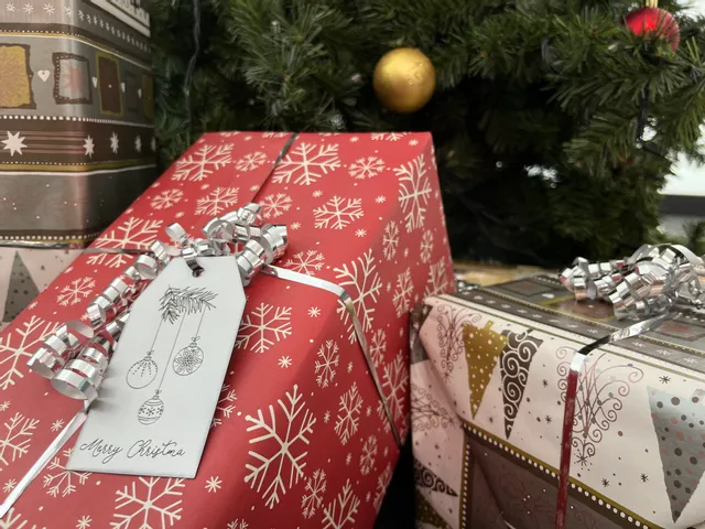 Laser-engraved holiday gift tag on Christmas present, made with Trotec laser cutter