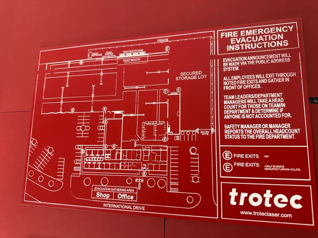 Trotec laser engraved fire evacuation map with emergency instructions on red acrylic