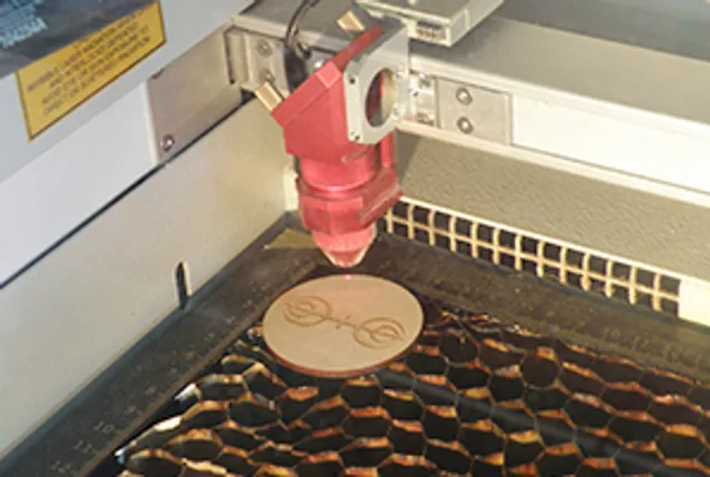 ハニカムベッドに円形の木製デザインを彫刻するトロテック・CO₂レーザーカッター