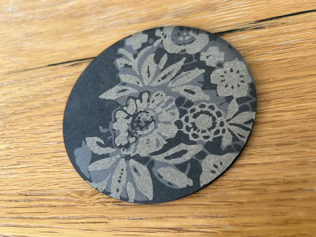 Floral pattern engraved on black card using Trotec CO₂ laser cutter