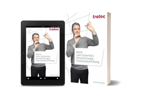 L'eBook de Trotec sur le marquage laser de sécurité et le marquage fonctionnel présenté sur tablette et livre imprimé.