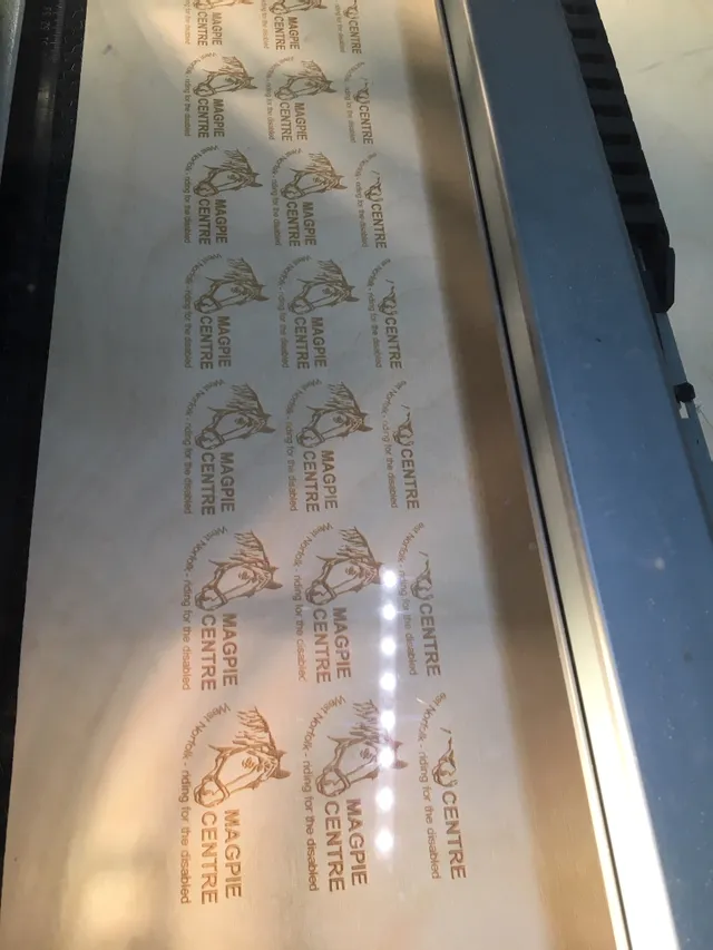 Trotec gravure laser des logos des chevaux du Centre Magpie sur du bois avec la machine de la série Speedy