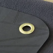 Textile découpé au laser avec œillet en laiton, découpé à l'aide de la machine de découpe laser Trotec CO₂.