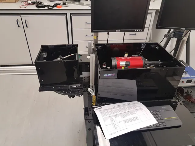 STORM laser marking system with red laser module and control monitors in laboratory setup