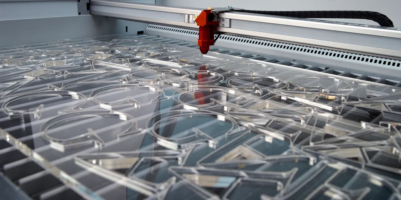 Trotec laser cutter engraving clear acrylic letters with precision