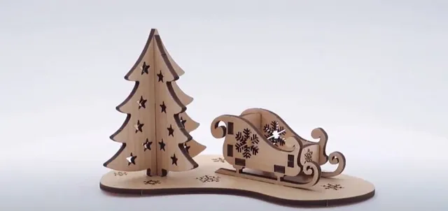 Laser-cut wooden Christmas tree and sleigh made with Trotec CO₂ laser engraving machine