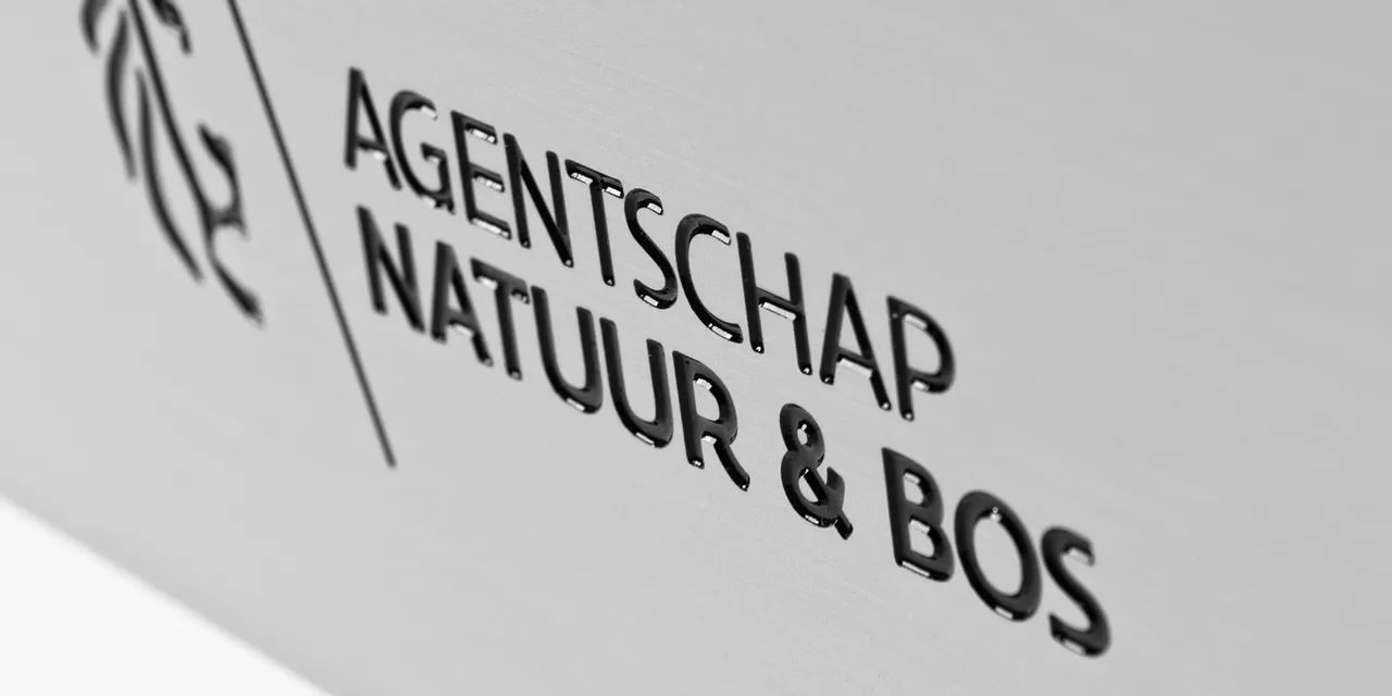Laser-engraved metal sign created with Trotec laser cutter showing Agentschap Natuur & Bos logo