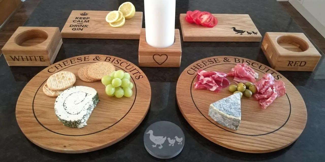 Trotec laser-engraved wooden cheese boards and coasters with food and decorative text designs