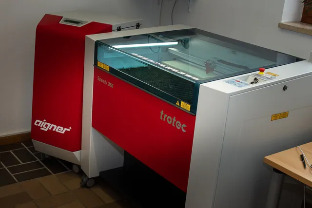 Trotec Speedy 360 CO₂ laser cutter in workspace setup for engraving and marking