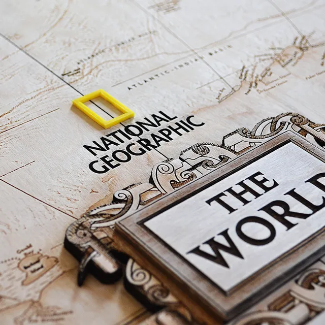 Laser-engraved wooden map featuring National Geographic logo and intricate detailing