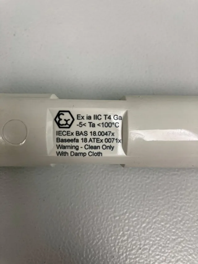 Close-up of IECEx certified device label showing electrical safety and cleaning instructions