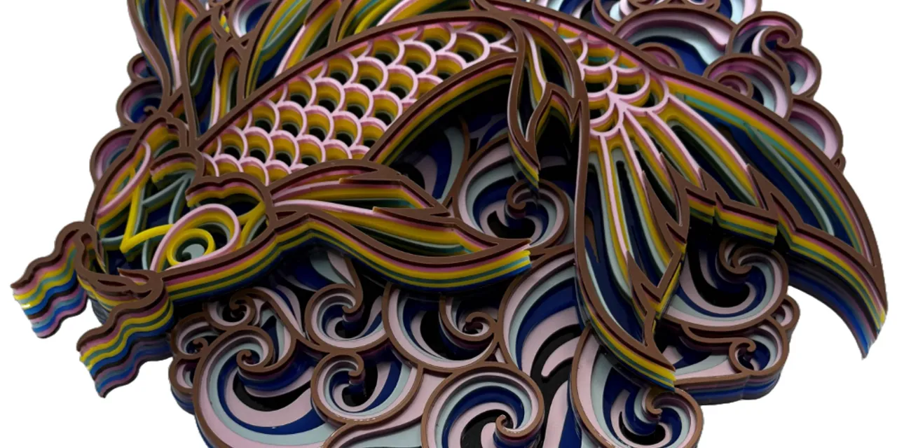 Intricate layered paper koi fish design made with Trotec laser cutter and engraving machine