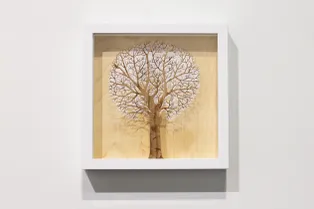 Laser-cut wooden tree artwork created with Trotec CO₂ laser cutter in a white frame