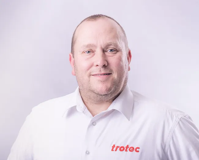 Trotec employee in branded shirt representing laser engraving and cutting technology