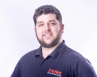 Trotec team member wearing branded polo shirt for laser marking cutting engraving