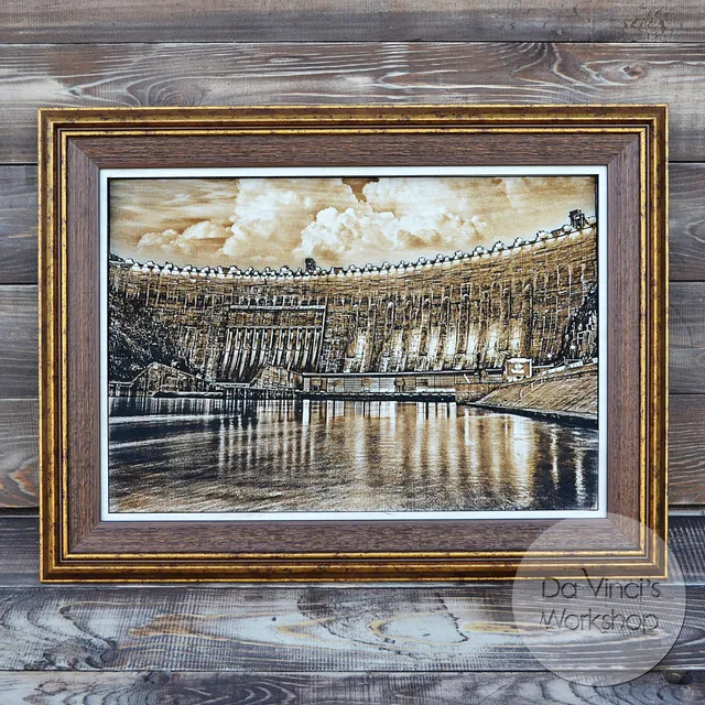 Framed wood engraving of dam created with Trotec Speedy series CO₂ laser cutter