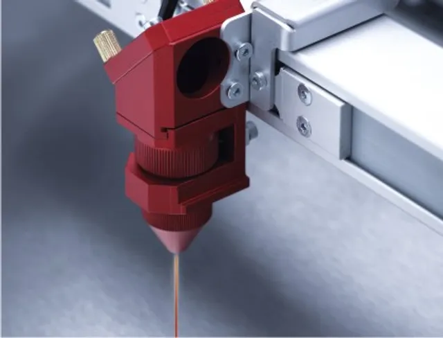 Close-up of Trotec laser head from Speedy series during precision laser engraving