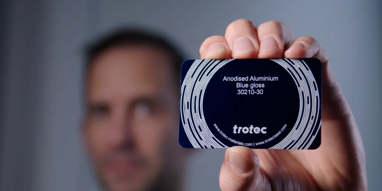 Trotec anodised aluminium blue gloss sample card held in hand for laser engraving