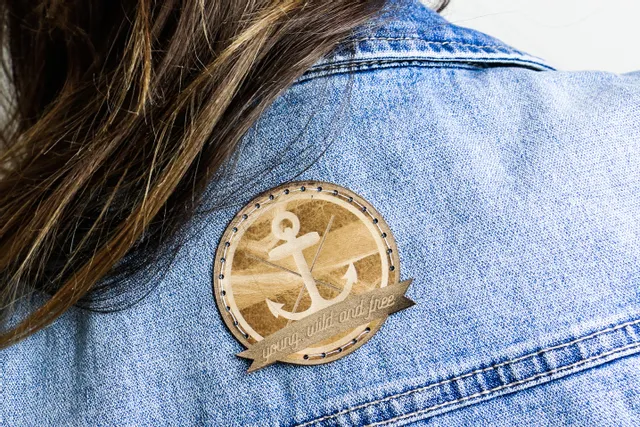 Leather badge with anchor design and 'young, wild and free' text engraved using Trotec laser cutter