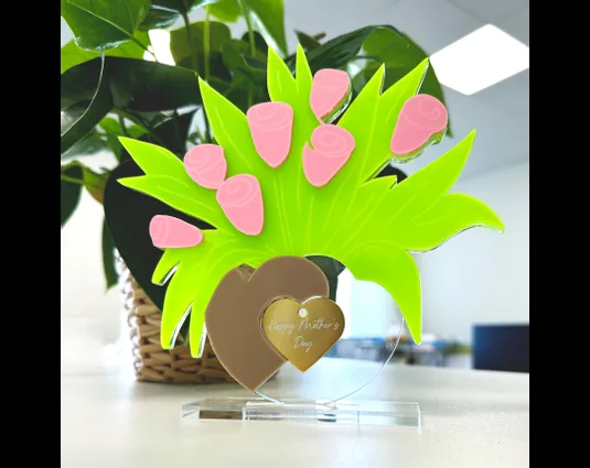 Laser-cut acrylic Mother’s Day decoration made with Trotec laser cutter and engraved heart tag