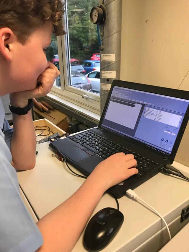Student using Trotec Ruby software on laptop to prepare laser engraving design