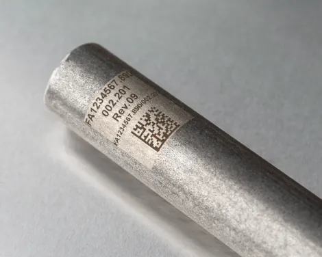 Znakowanie laserowe Trotec na metalowej tubie pokazujące kod matrycy danych i numer seryjny