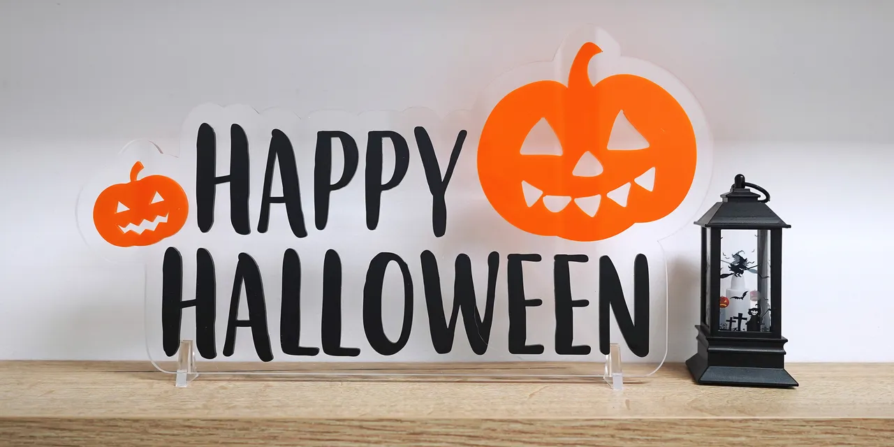 Laser-cut acrylic Happy Halloween sign with pumpkins made using Trotec laser cutter