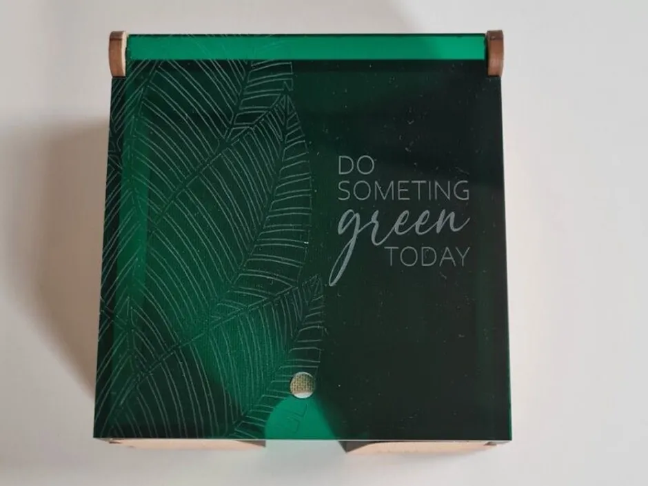 Laser-engraved green acrylic sign with leaf pattern and 'Do something green today' text using Trotec laser cutter