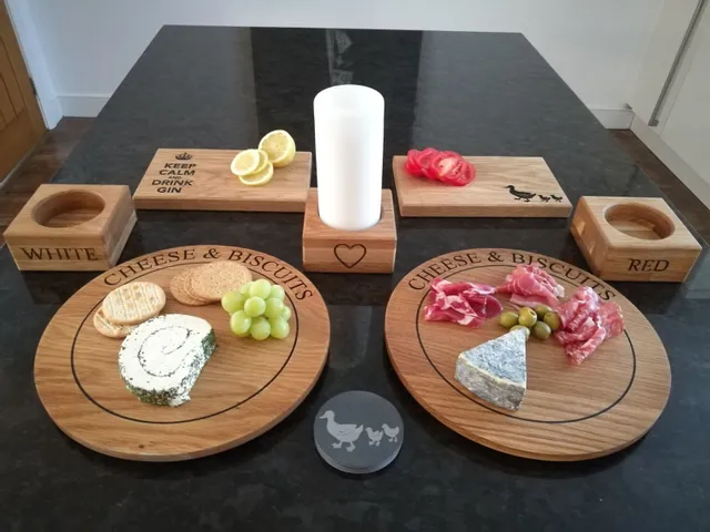 Trotec laser-engraved wooden cheese boards and coasters with food and decorative text designs