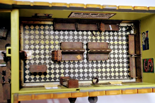 Sala de espera de estación de tren vintage en miniatura con bancos y suelo de baldosas a cuadros, probablemente cortada con láser con la máquina Trotec