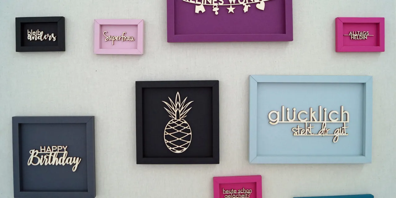 Laser-cut wooden words and shapes in colorful frames made with Trotec laser engraving machine