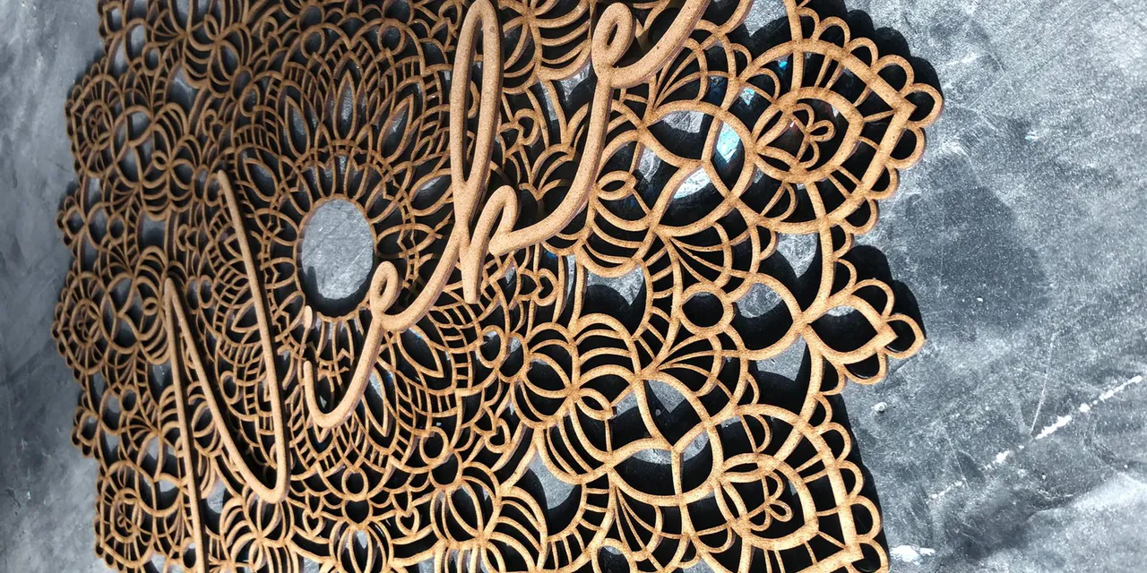 Intricate wooden mandala cut with Trotec CO₂ laser cutter from the Speedy series